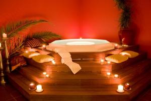 a bath tub with lights and candles in a room at Cerro Mar Atlantico & Cerro Mar Garden in Albufeira
