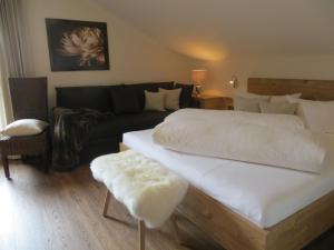 1 dormitorio con 1 cama grande y 1 sofá en Gästehaus Pfister Maria en Hippach