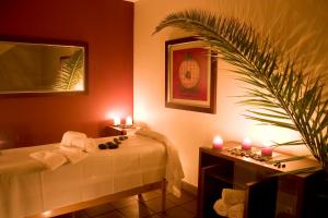 a bathroom with a table with candles and a bed at Cerro Mar Atlantico & Cerro Mar Garden in Albufeira