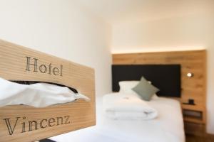 Postel nebo postele na pokoji v ubytování Boutique-Hotel Vincenz
