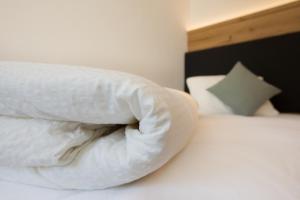 Postel nebo postele na pokoji v ubytování Boutique-Hotel Vincenz