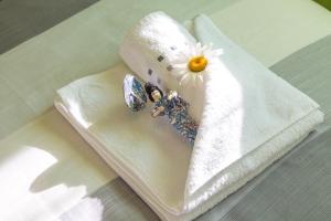 a white towel with a flower on top of it at House Malkoc in Saborsko +42 photos