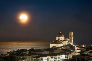 a full moon rising over a city at night at Ocean Lounge in Altea