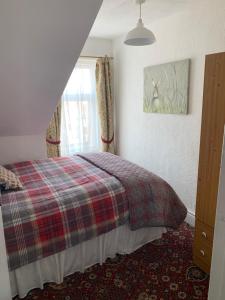 a bedroom with a bed and a window at Sarnia holiday flats in Blackpool