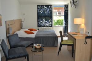 a bedroom with a bed and a chair and a desk at Best Western Hotel Hillerød in Hillerød +76 photos