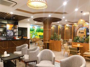 a restaurant with chairs and tables and a bar at Gia Quý Hotel in Cao Bằng