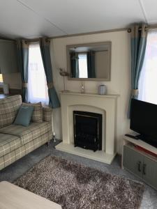 A television and/or entertainment centre at Deluxe Riverside Static Caravan