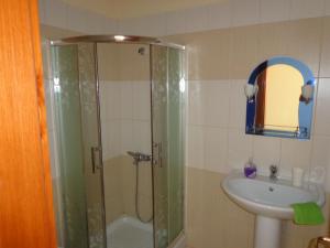 a bathroom with a shower and a sink at Olympian Rooms in Dhërmi