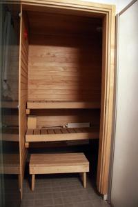a sauna with a wooden bench in a room at Apartment Asemakatu 20 in Kuopio
