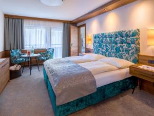 Posteľ alebo postele v izbe v ubytovaní Hotel-Garni Jakober