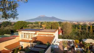 a view of a house with a mountain in the background at Hotel Forum in Pompei