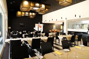 uma sala de jantar cheia de mesas e cadeiras em RIDE Surf Resort & Spa em Peniche