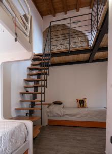 a bedroom with a staircase and a bed in a room at Agriturismo De Ferrari in Onzo