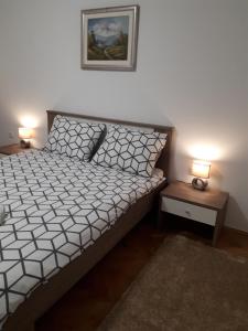 a bedroom with a bed and two night stands at Apartman Škribulja in Županja