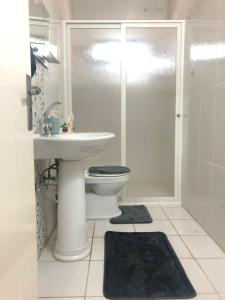 a bathroom with a toilet and a sink and a shower at Homeplace Sour in Soûr