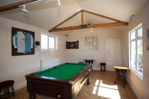 a room with a pool table in it at Links Country Park Hotel in Cromer
