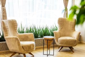 two chairs and a table in front of a window at City Avenue Hotel by HMG-Free Parking-Free Wi-Fi in Sofia