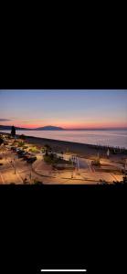 a view of a parking lot next to the ocean at Villa Un bel posto Sea View in Nea Vrasna