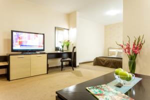 A television and/or entertainment centre at City Avenue Hotel by HMG-Free Parking-Free Wi-Fi