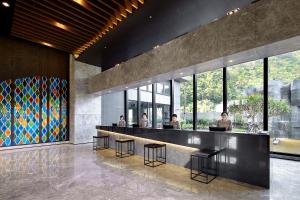 a lobby with people sitting at a bar at Lakeshore Hotel Suao in Suao