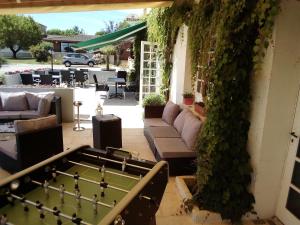 a patio with a pool table and ivy at Le Vieux Logis de Clam in Clam