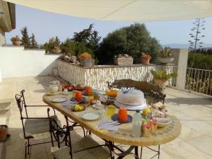 una mesa con comida en el patio en Casa d' Artista B&B, en Ozieri