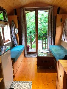 a view of a room with a door in a house at Millygite Chalet-on-wheels by the river in Milly-la-Forêt