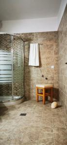 a bathroom with a shower and a table in it at Venetia's Stone House in Potamia