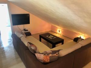 a living room with a couch and a tv at Apartments Simic in Kamenari