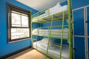 a room with two bunk beds and a window at The Phoenix Hostel in London