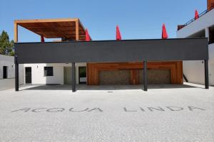 a building with a black roof and a garage at Residence ACQUA LINDA Porticcio in Porticcio