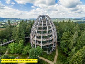 a large building in the middle of a forest at Ferienwohnung Fernblick in Neukirchen vorm Wald