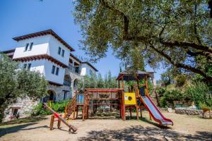 a playground in front of a house at Geranion Village in Nikiti