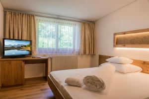 Posteľ alebo postele v izbe v ubytovaní Apartments Tschanun