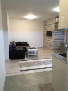 a living room with a couch and a table at Apartments Park Place in Sandanski