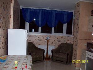 - une cuisine avec 2 chaises et un réfrigérateur blanc dans l'établissement Квартира у моря, à Odessa
