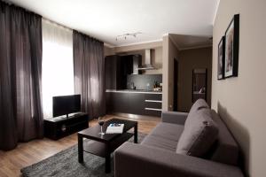 a living room with a couch and a table at Soho Apartments in Bitola