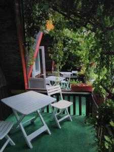 a picnic table and chairs on a patio at casa paltin vila si cabane in Poiana Stampei