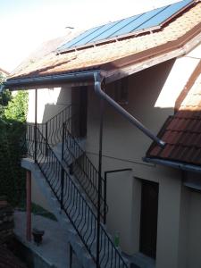 a building with a staircase with a solar roof at Privat Lucia in Nová Lesná
