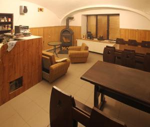 a restaurant with a table and chairs and a wood stove at Privat Lucia in Nová Lesná