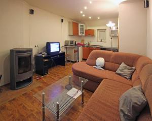 a living room with a couch and a tv at Privat Lucia in Nová Lesná
