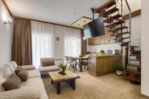 a living room with a couch and a table at Hotel Apostolite in Sandanski