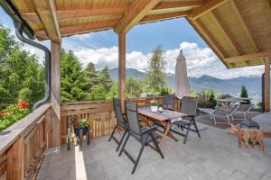 a patio with a table and chairs and a umbrella at Fuchsmaurer Plose - Apartments bei Brixen in Bressanone