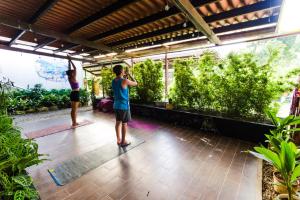 two men doing yoga in a room with plants at Bodhi El Valle in Valle de Anton
