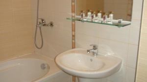 a bathroom with a sink and a shower and a tub at Borovets Gardens Studio D36 in Borovets +48 photos