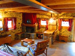 a living room with a stone building with a fireplace at Chalet Cuore Selvatico in Monno