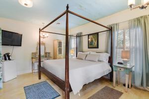 a bedroom with a four poster bed and a television at T'Frere's Bed & Breakfast in Lafayette