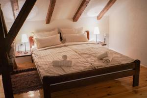 a bedroom with a large bed with two towels on it at Epicenter in Niš