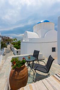a patio with two chairs and a table on a roof at Avra Guestroom in Apollonia