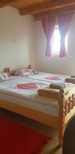 a bedroom with a large bed with a window at Studio apartment Pitomine in Žabljak